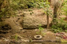 -local-roads-land-and-parking-lots-it-arrives-through-immense-pipes-shored-up-by-these-sand-bags.jpg